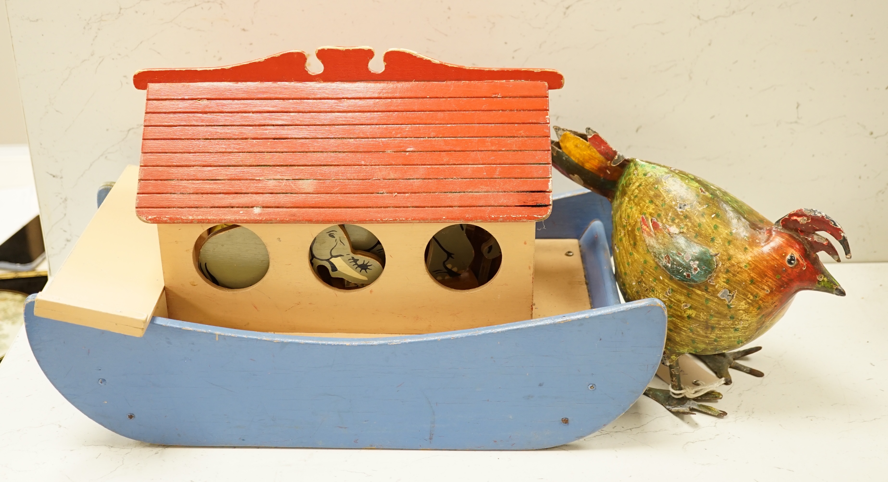 A painted ply Noah's Ark with animals, two Victorian iron door stops, a painted toleware cockerel and an oil on canvas of a harbour view. Condition - varies